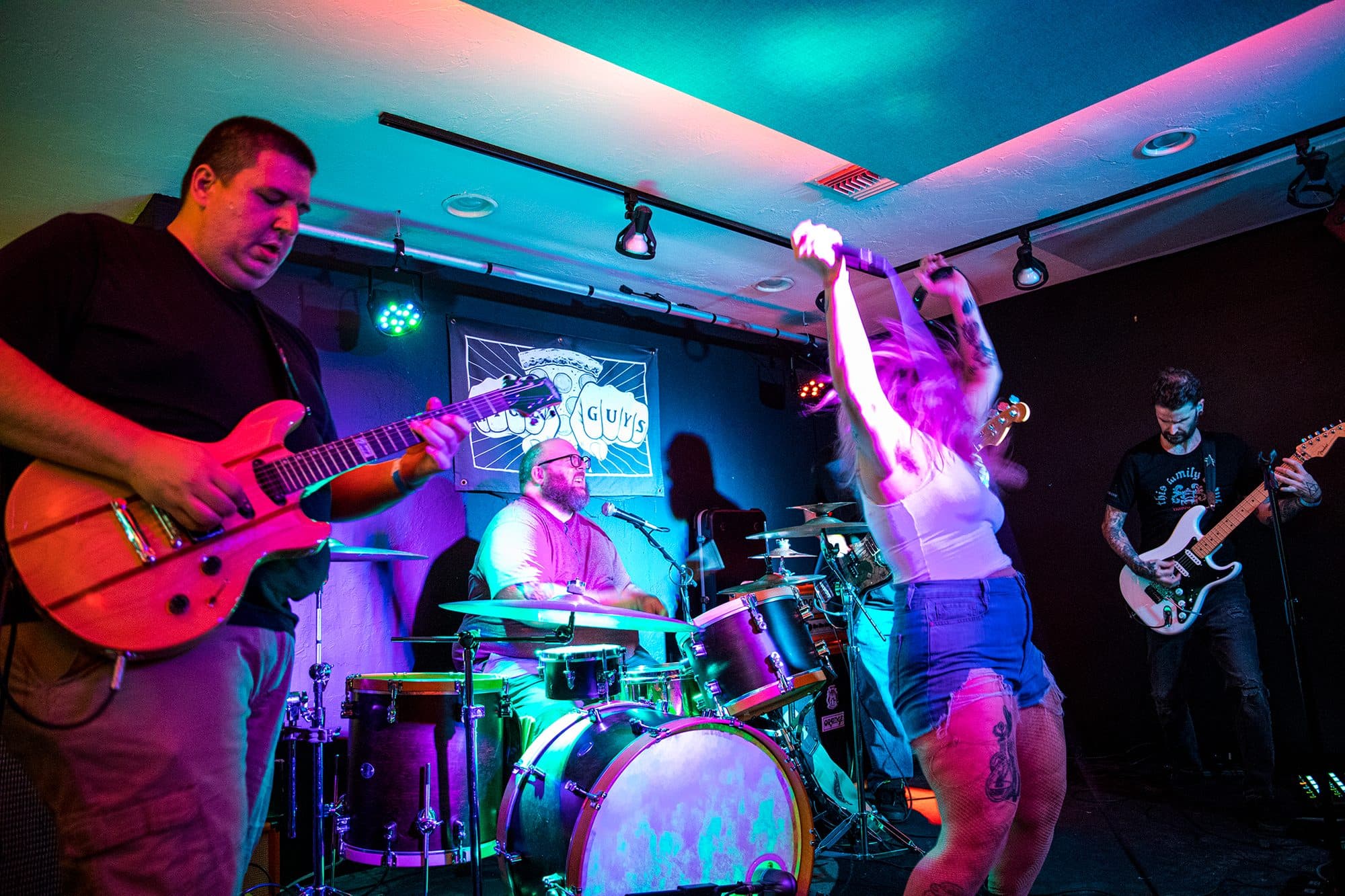 Full band under rainbow stage lights